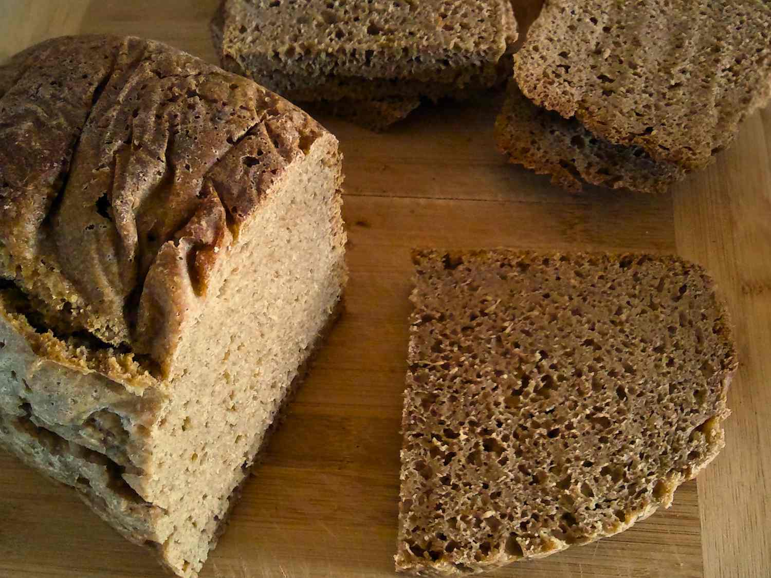 Sourdough Bread being sliced on a wooden board