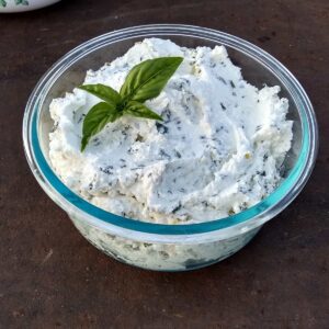 quark cheese with herbs in a bowl.