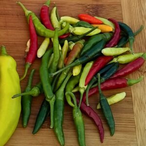 collection of various peppers on a cutting board
