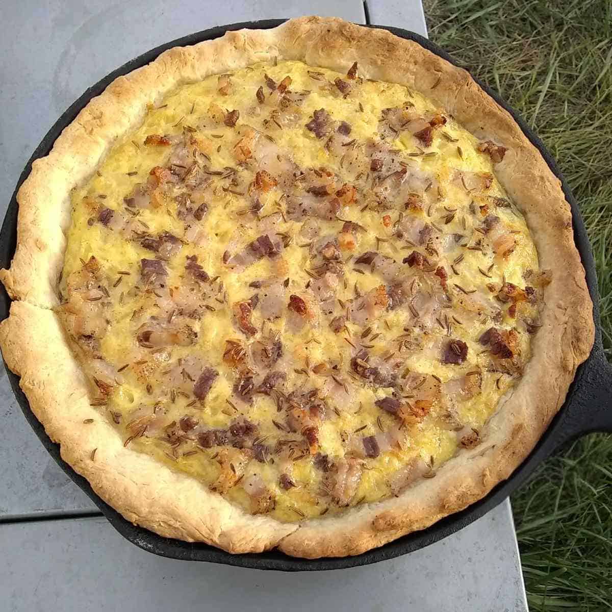 fresh baked zwiebelkuchen, german onion pie in a cast iron pan