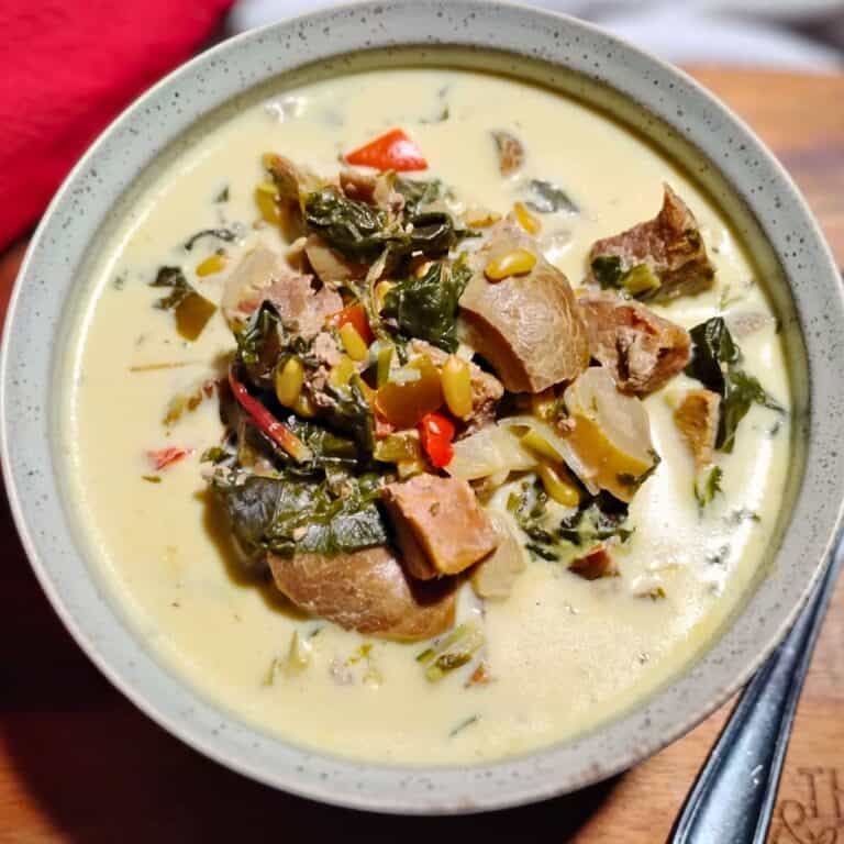 Mushroom chowder stew in a bowl with a spoon next to it and a red towel behind it.