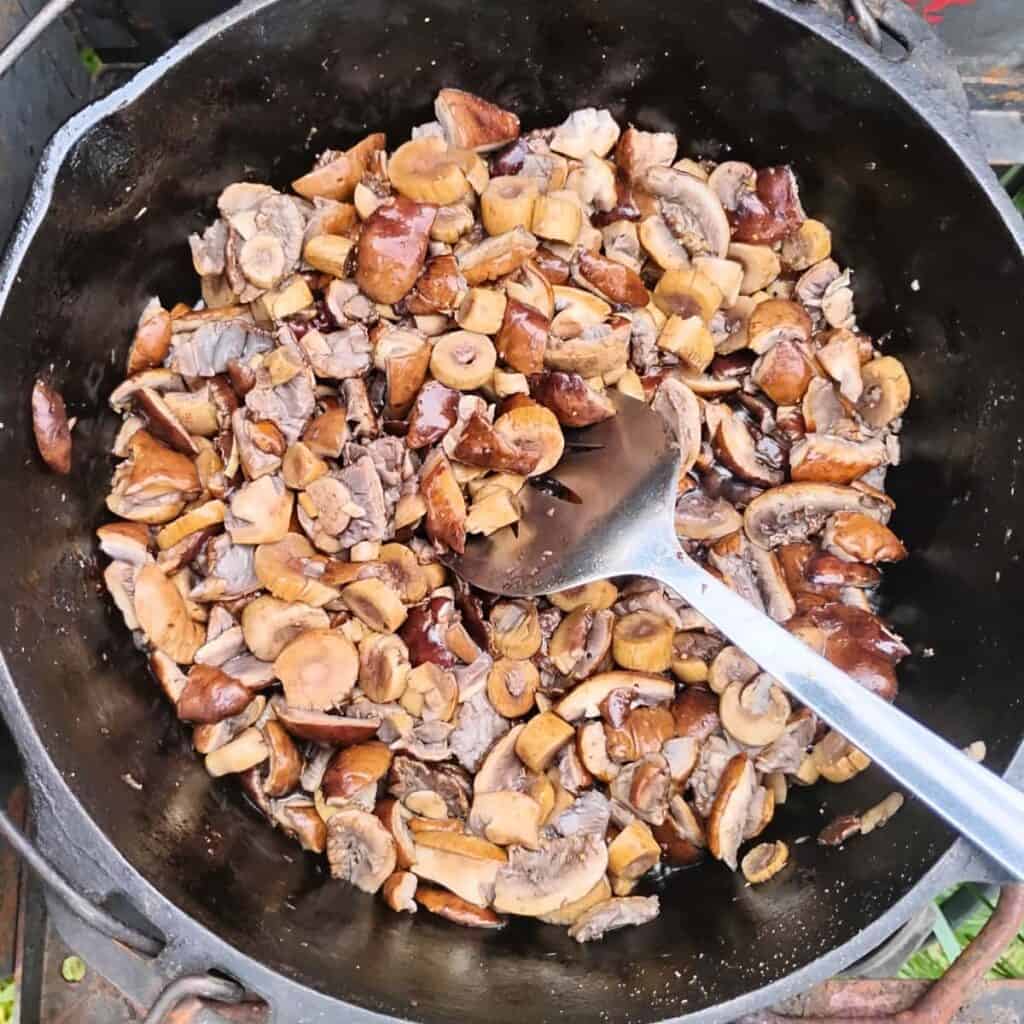 mushrooms getting fried in a dutch oven.