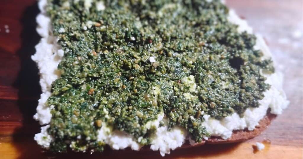 Wild greens pesto on a bread with clabber cheese.