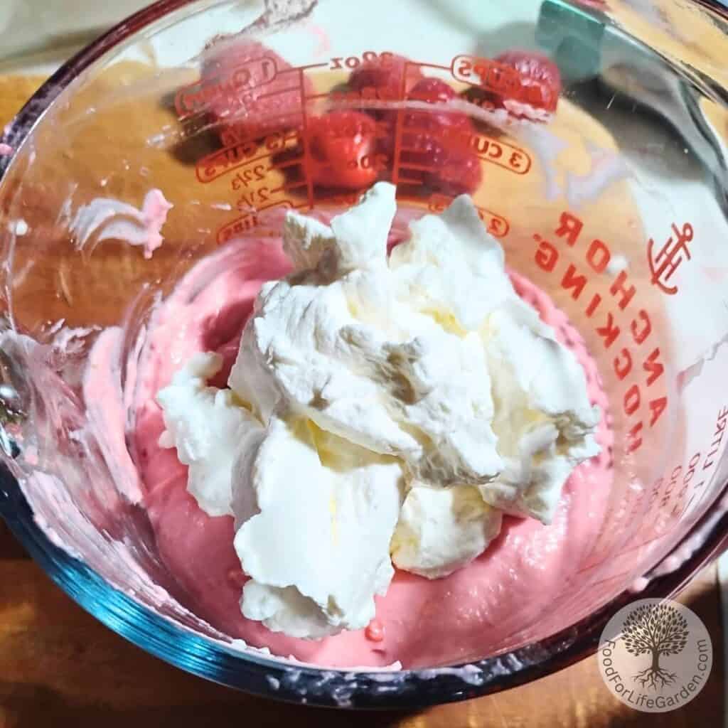 Strawberry mousse cream with a pile of whipped cream on top