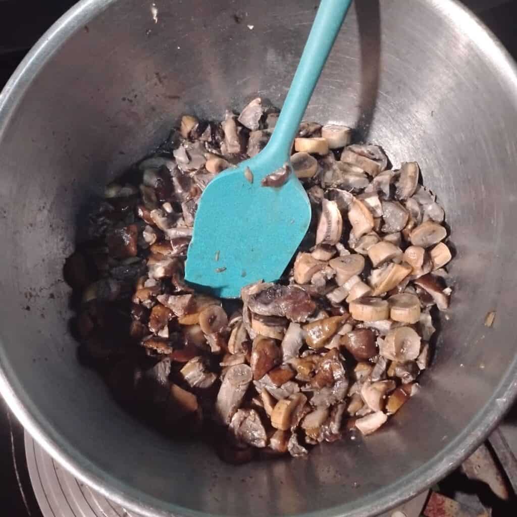 mushrooms in a bowl with a spatula