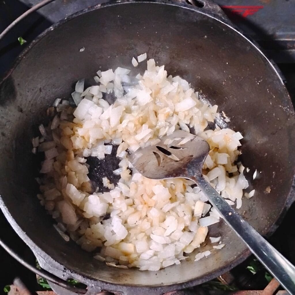 onions getting sauteed in a dutch oven.