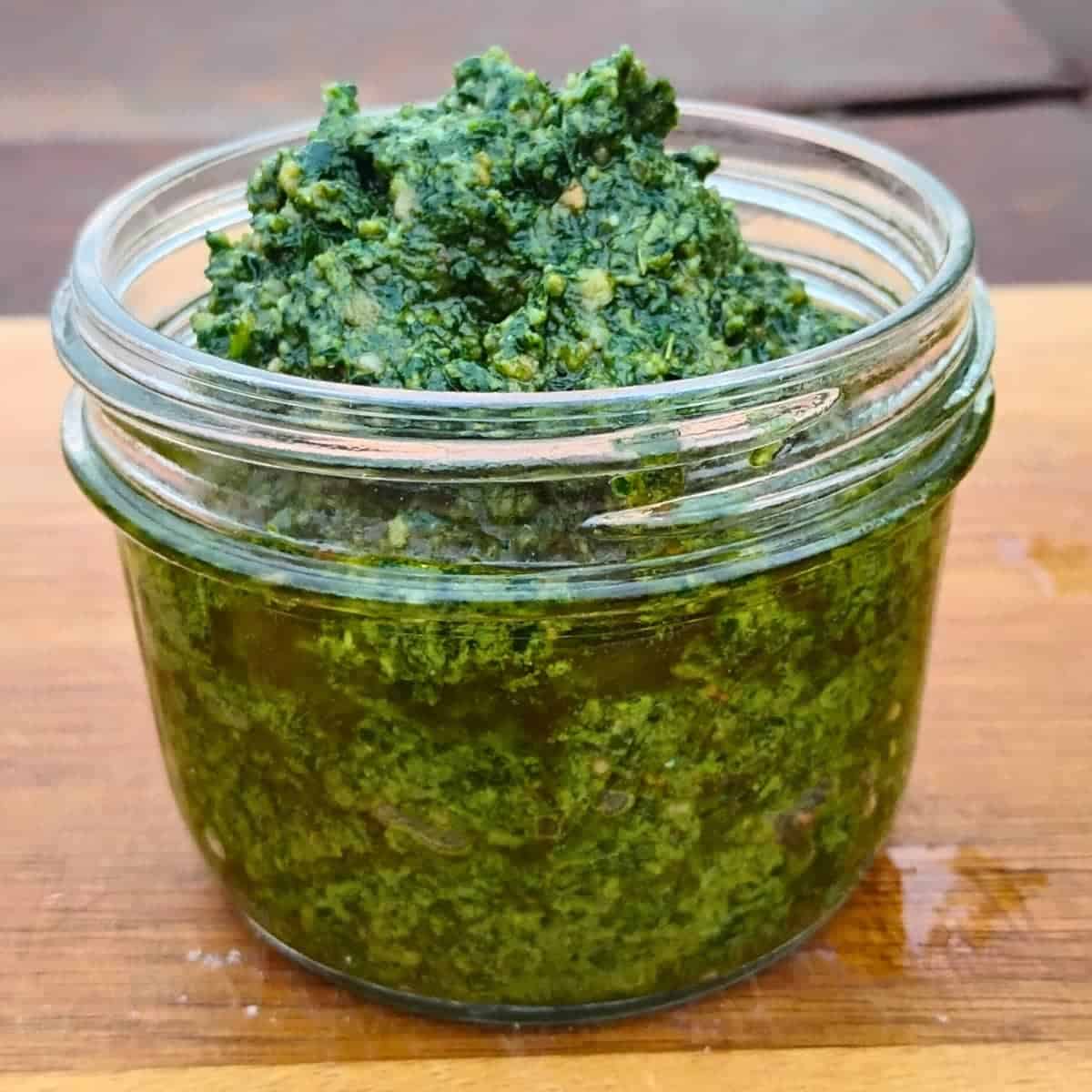 jar full of foraged wild greens pesto.
