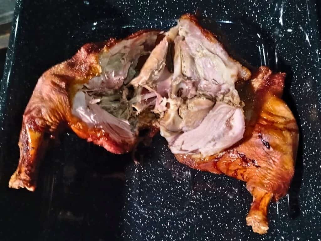 roasted pork butt split open to remove the meat.