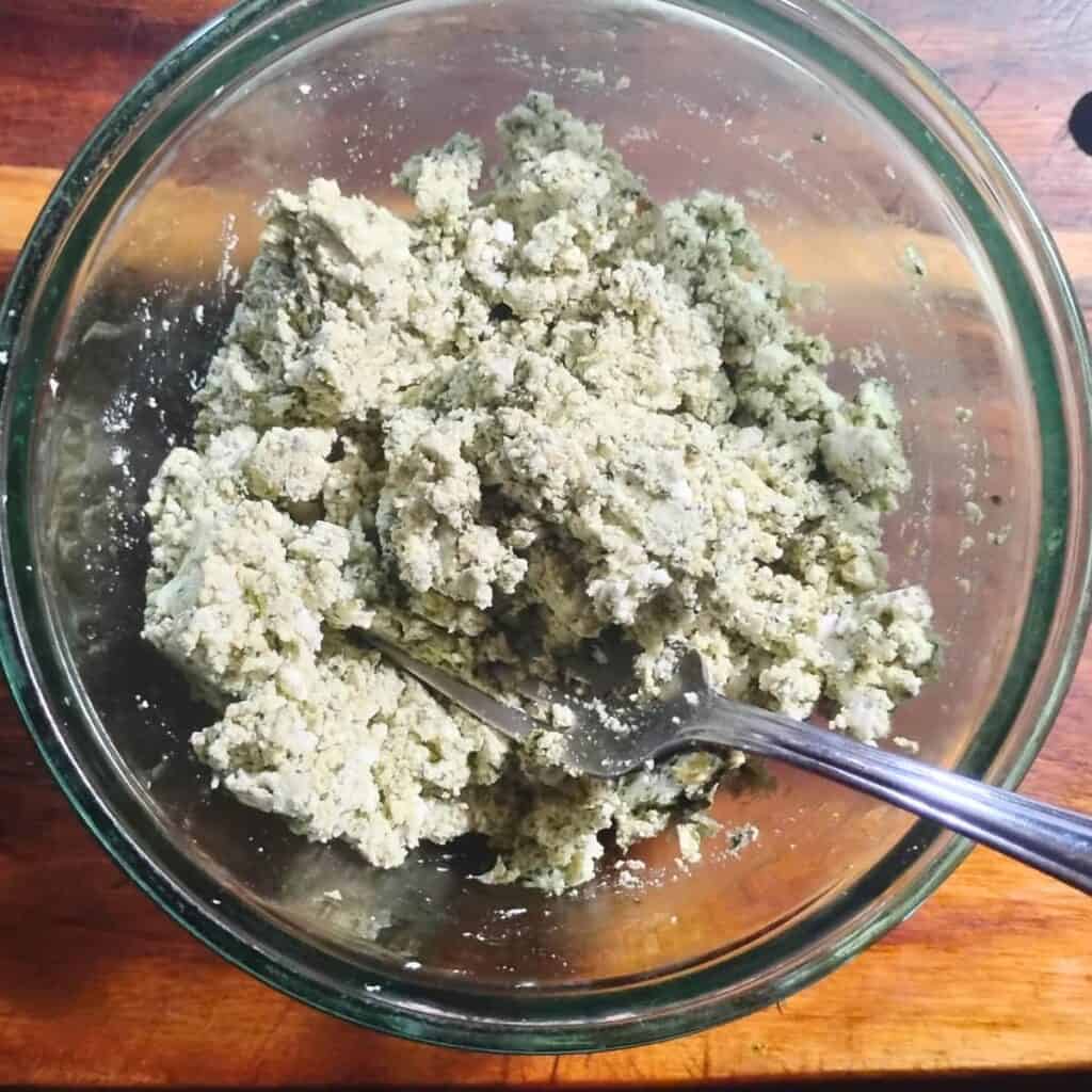 chevre cheese mixed with wild greens pesto and cantaloupe hot sauce to use as a spread on bread.