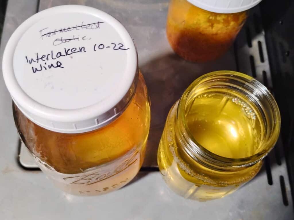 homemade wine in a canning jar and some measured out to use in cooking