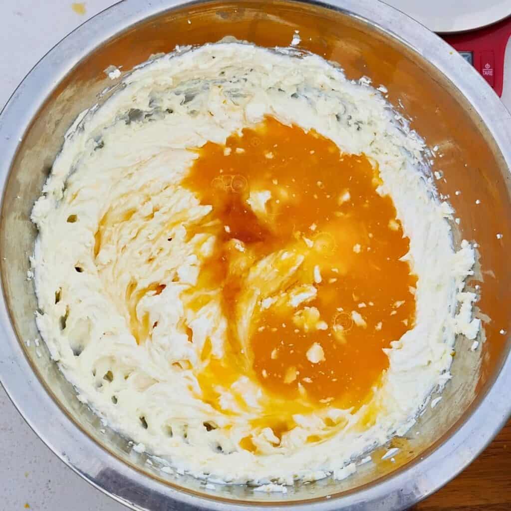 bowl full of whipped quark cheese with orange juice and honey added.