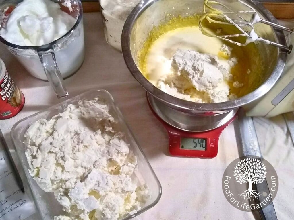 A bowl with cheese cake ingredients, with quark and heavy cream added.
