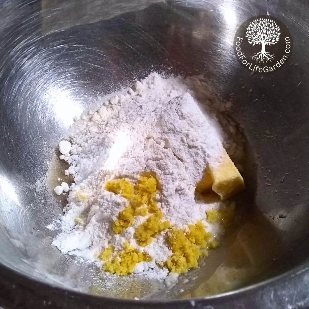 Cheesecake filling ingredients in a bowl. flour, lemon zest, butter.