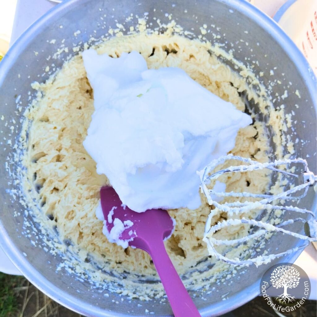firmly beaten eggwhites are added to the bowl of cheese batter.