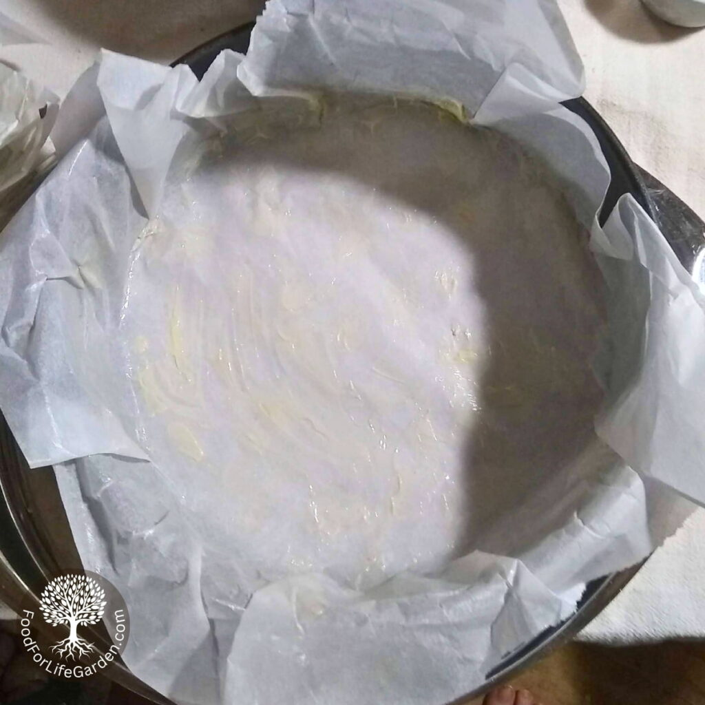 a cheese cake form with greased parchment paper