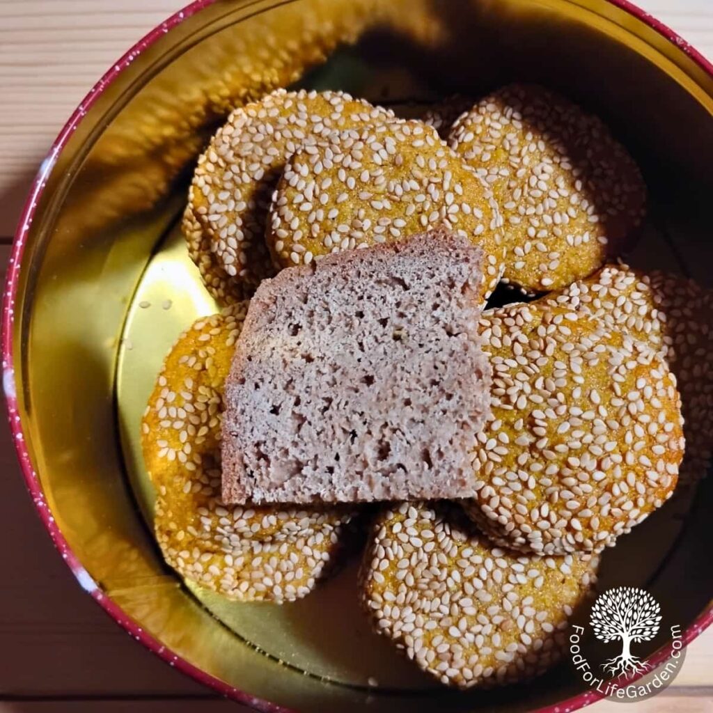 cookie tin with lemon spice cookies and a slice of bread to keep them soft and moist.
