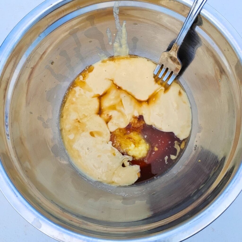 bowl with tahini paste and honey and a fork in it.