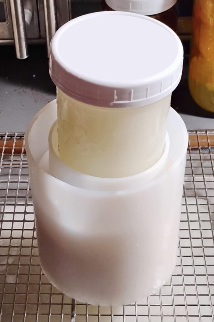 pressing feta cheese inside a cheese mold for shaping.