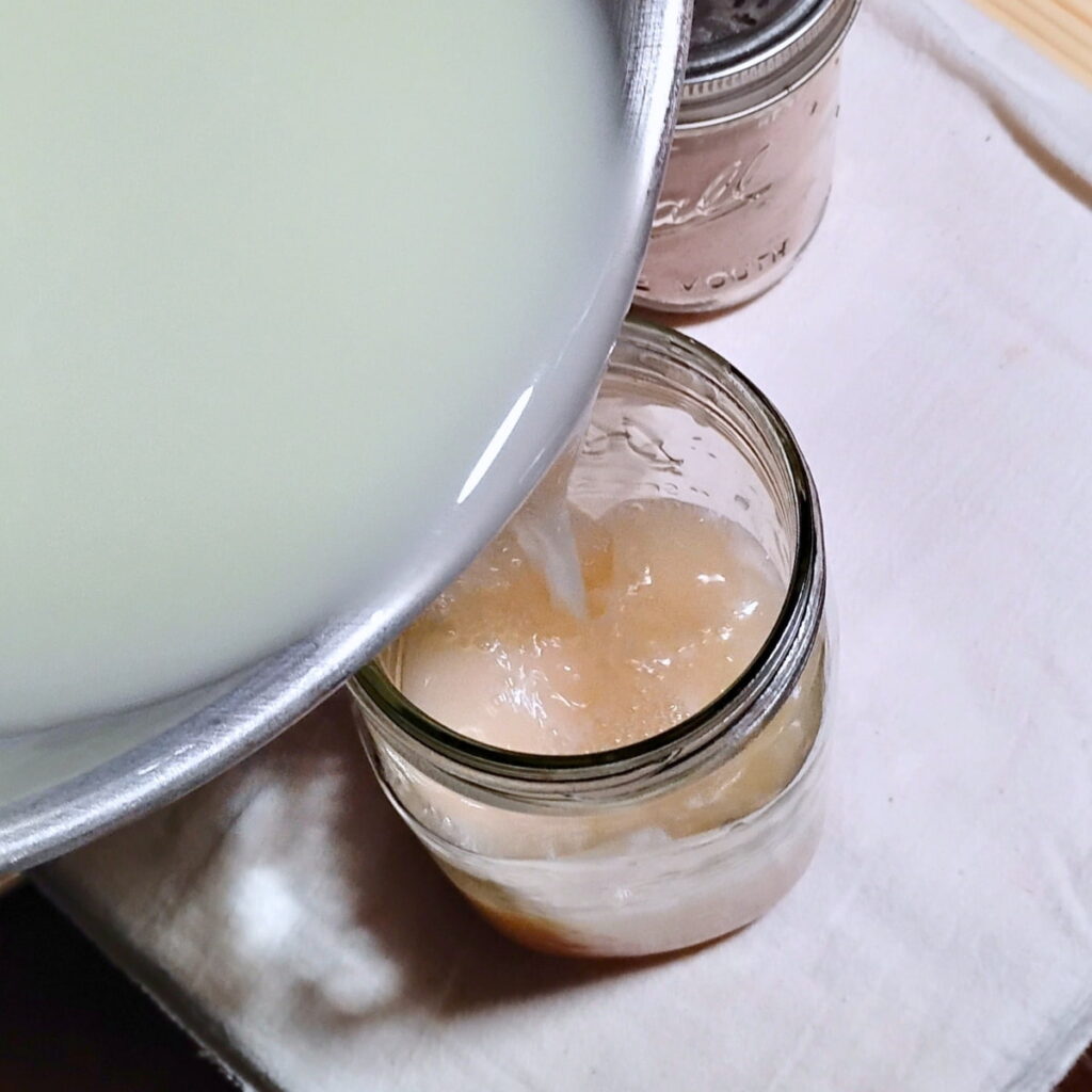 whey is getting poured into a glass with salt