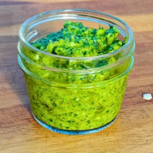 jar full of garlic scape and bolted onion pesto.