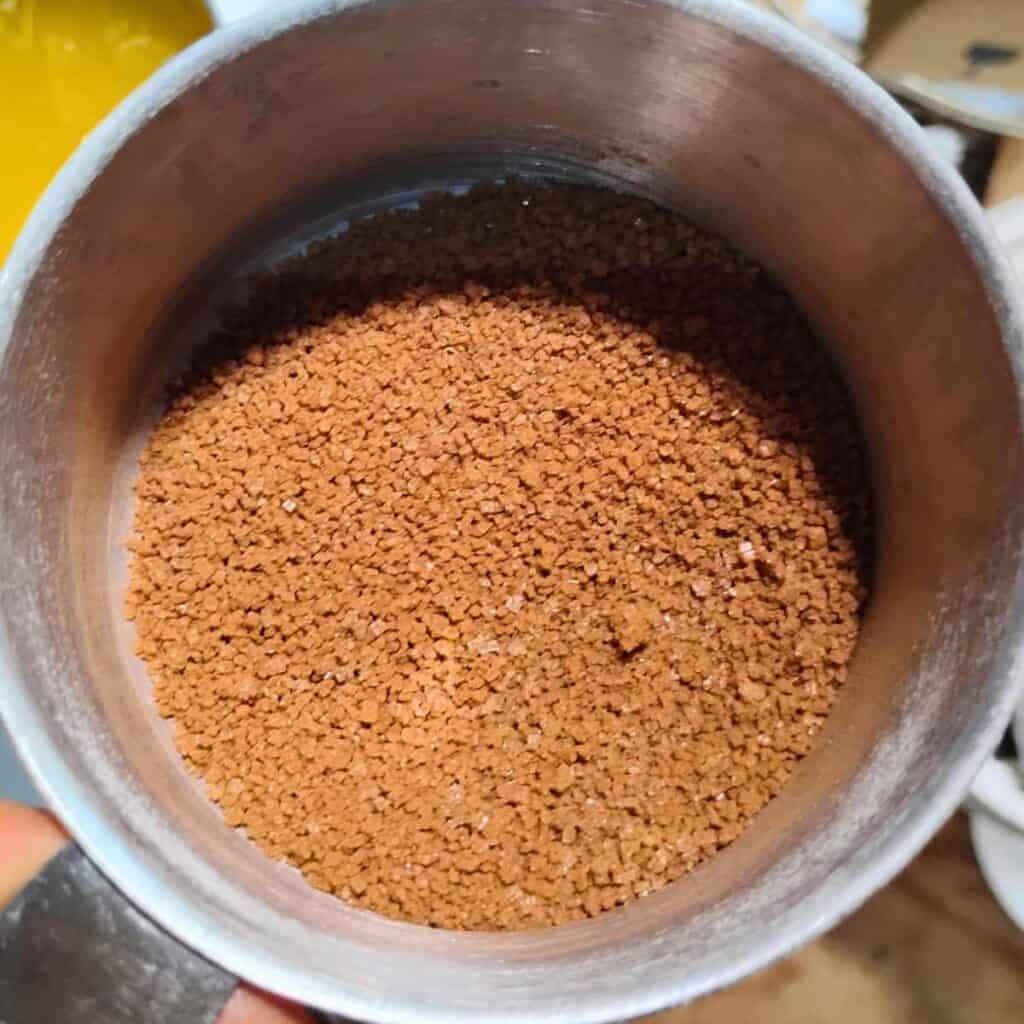 a measuring cup that contains cinnamon sugar mix