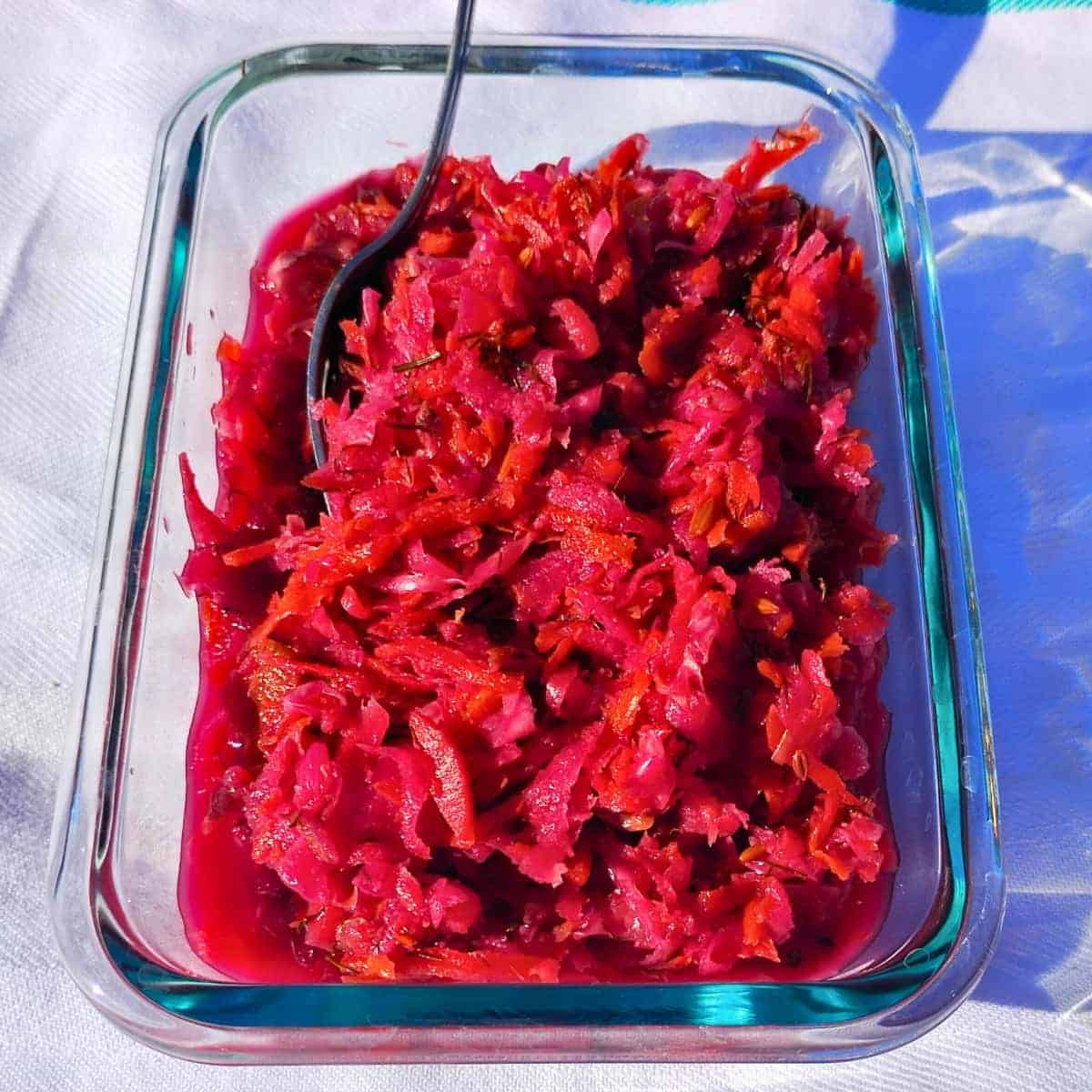A dish filled with red colored garden fermented coleslaw.