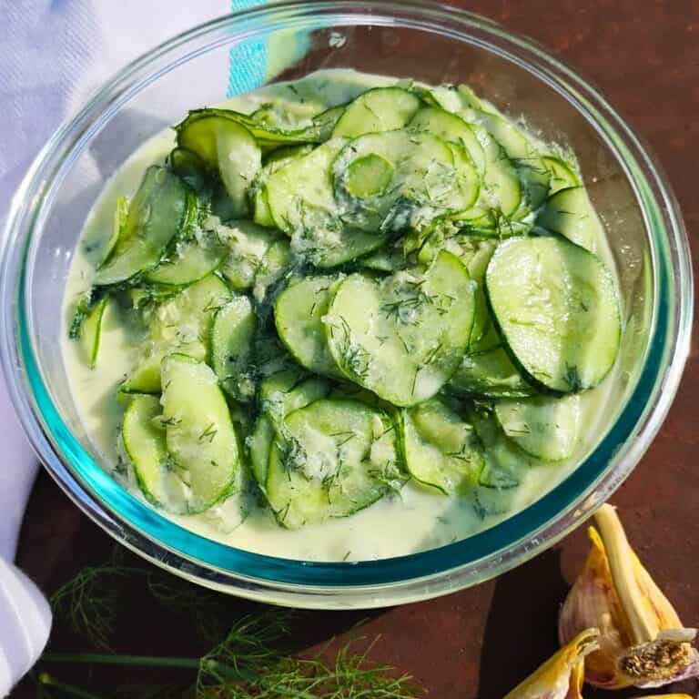 photo shows a bowl filled with fresh made creamy cucumber salad.