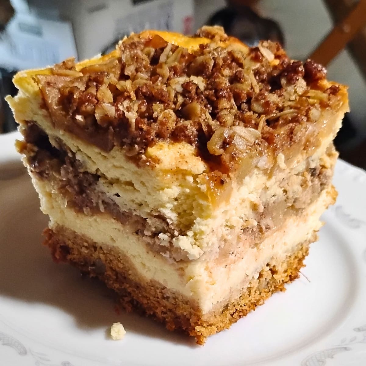 photo shows a layered apple pie cheesecake portion