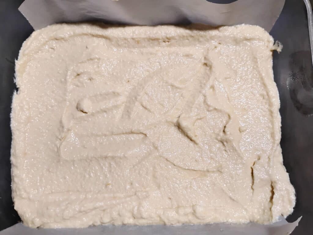 creamy cheese filling has been added to the baking dish.