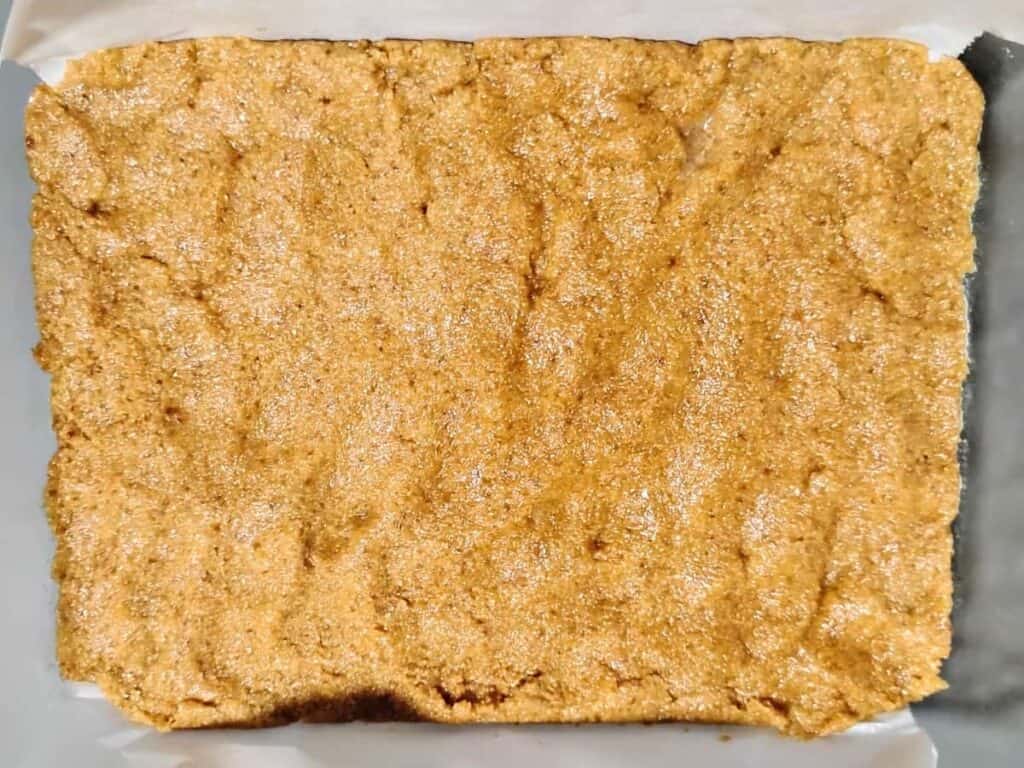 bottom of a cake pan with pastry crust pressed into it.