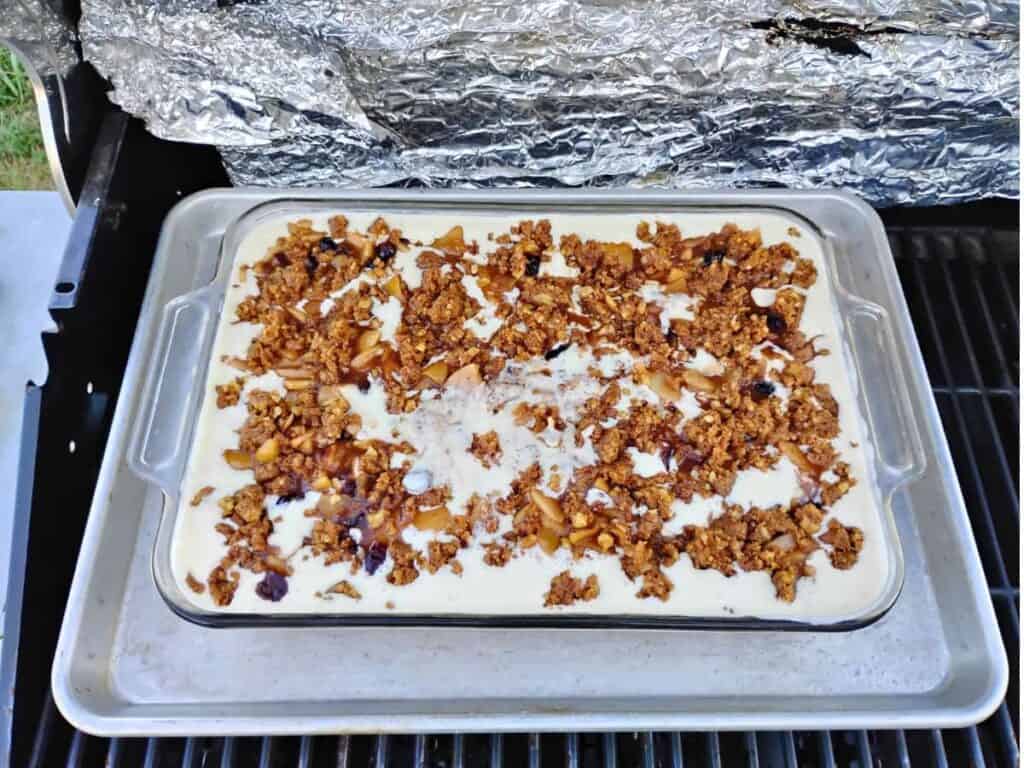 Ready to bake in a bbq grill. Cheesecake with apples, crumbles, cranberries, walnuts.