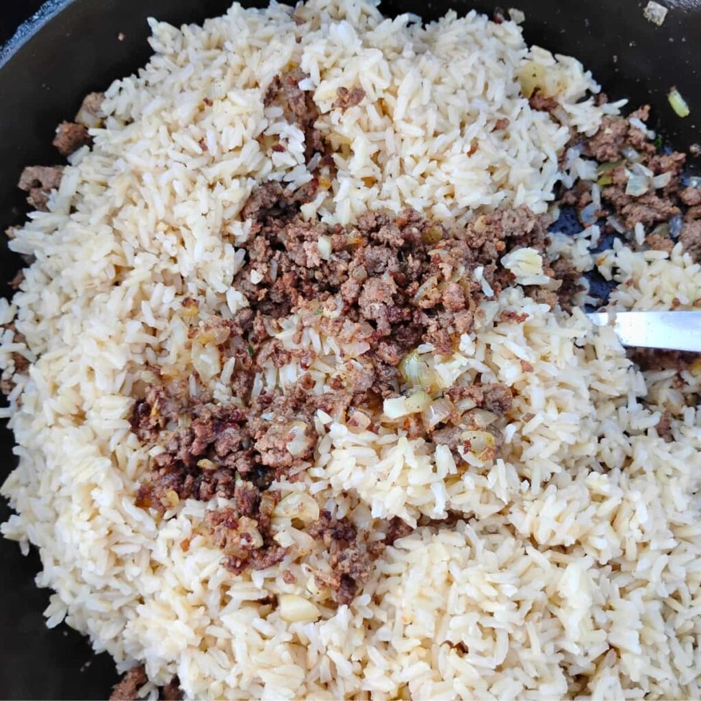 rice and beef getting mixed for stuffing peppers.