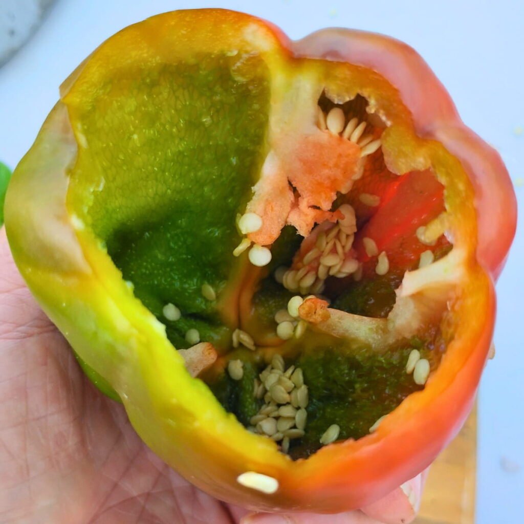 a bell pepper with seed cavity removed, ready to be cleaned out for stuffing.