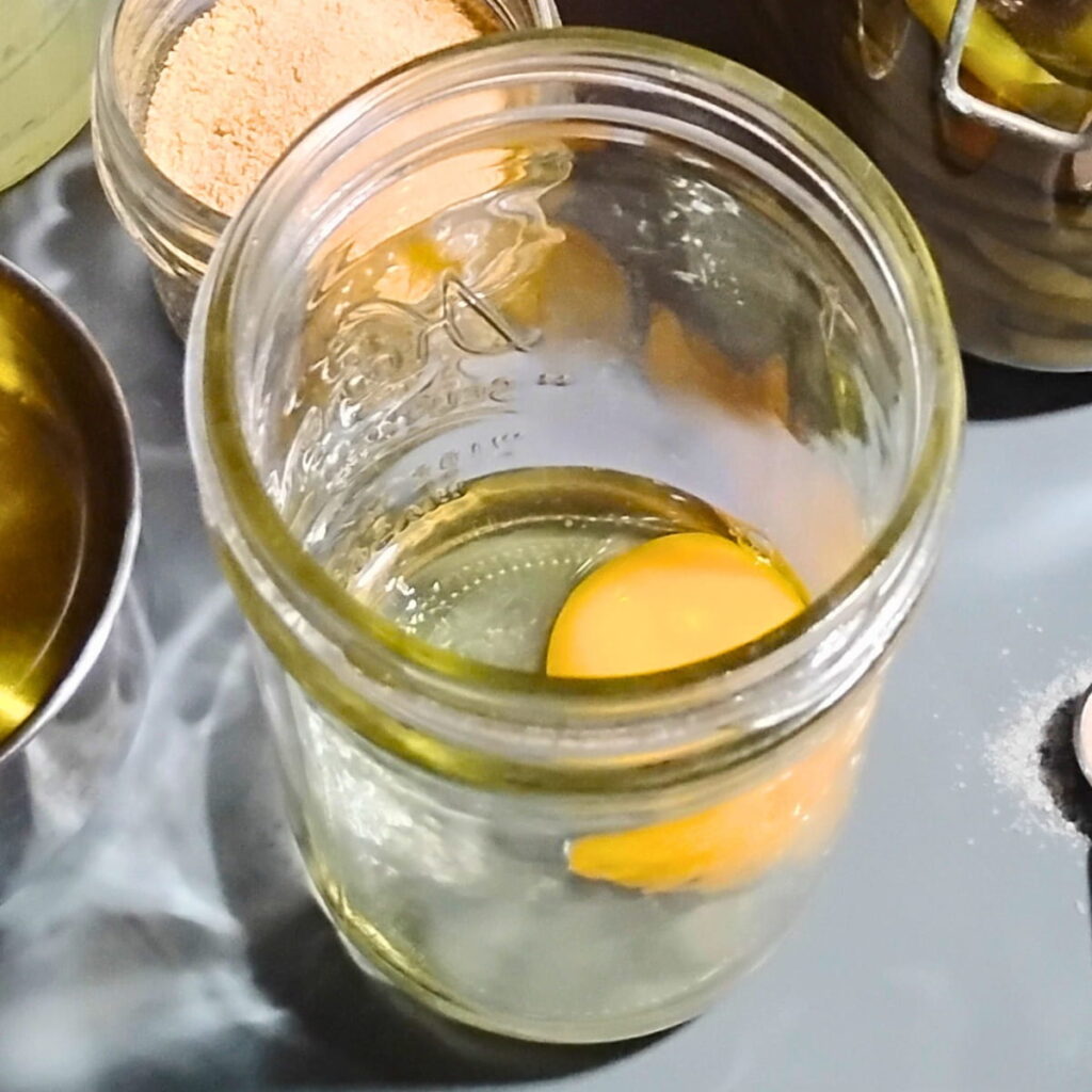 pint jar with an egg in it.