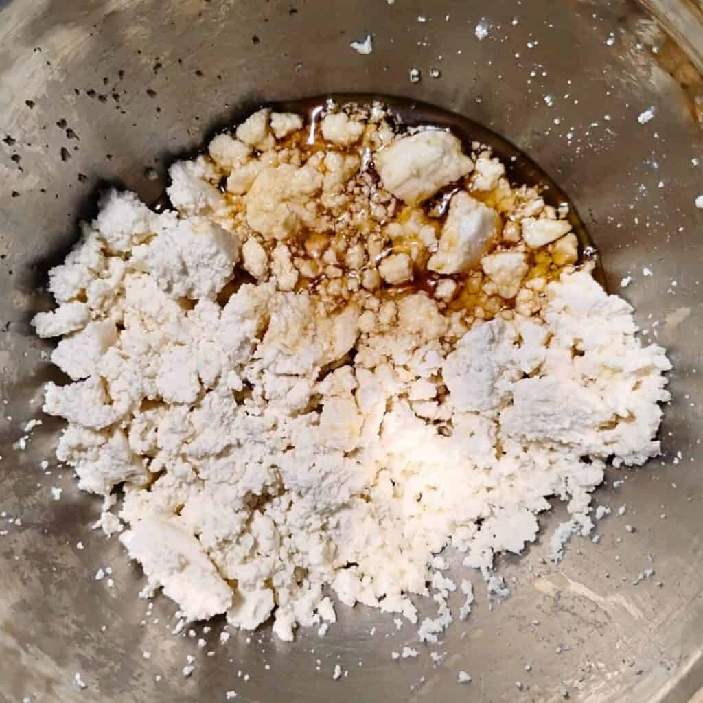 Honey and vanilla has been added to a bowl with queso fresco creamy cheese