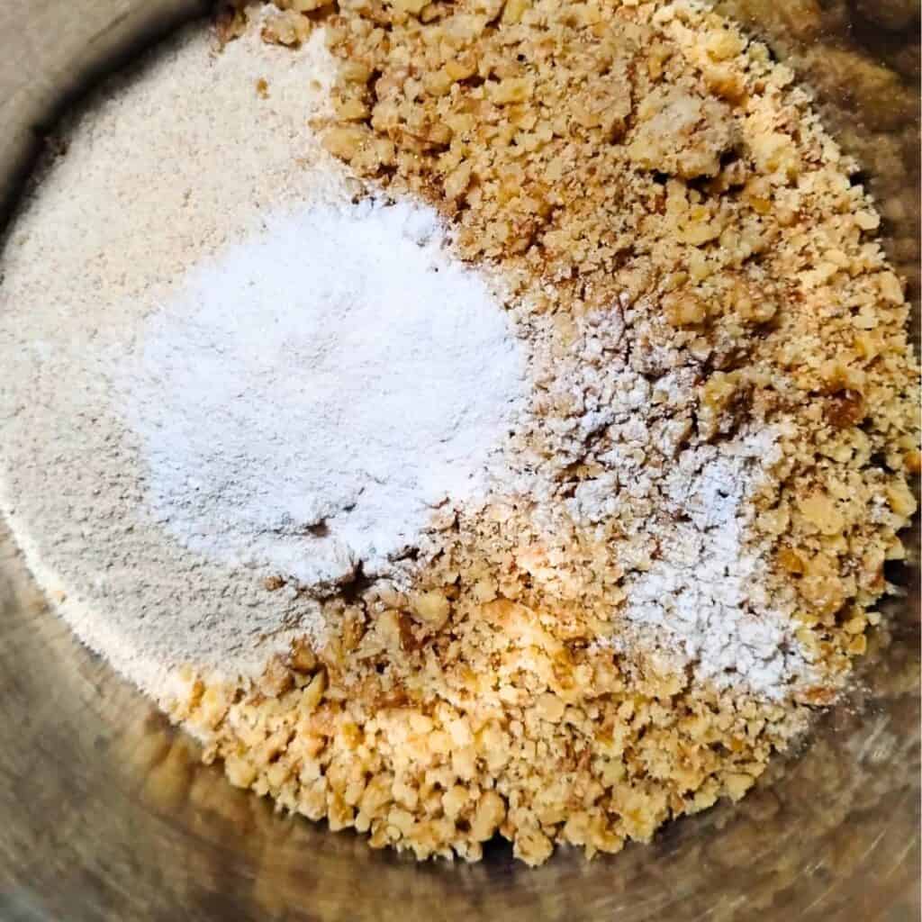 dry ingredients for the pie crust and crumble topping are added into a bowl.