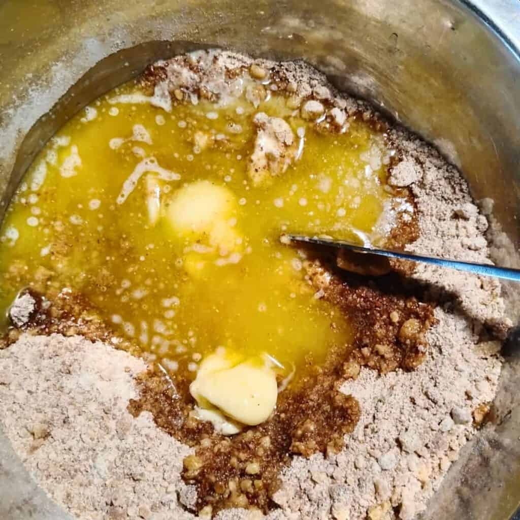 melted butter is added to ingredients in the bowl.