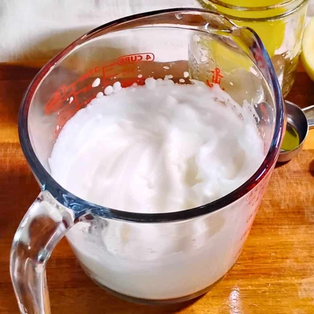 bowl filled with stiff, beaten egg whites ready for adding to the cheese batter.