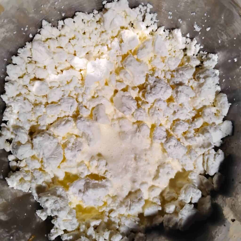 bowl filled with quark cheese and heavy cream ready for mixing.