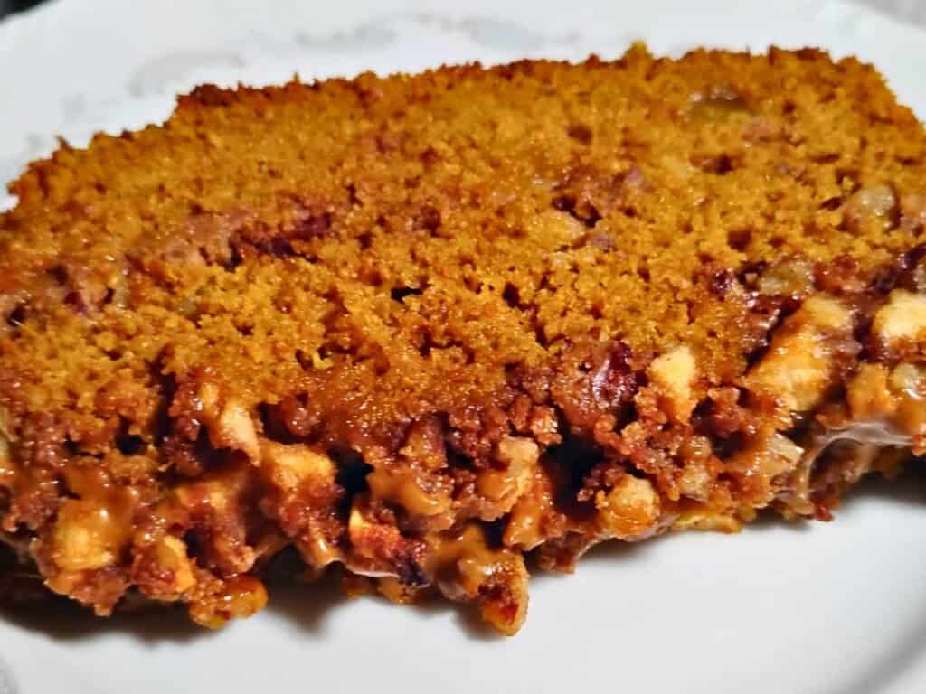 slice of sourdough pumpkin cake with Ginger & Apple Streusel on a plate.