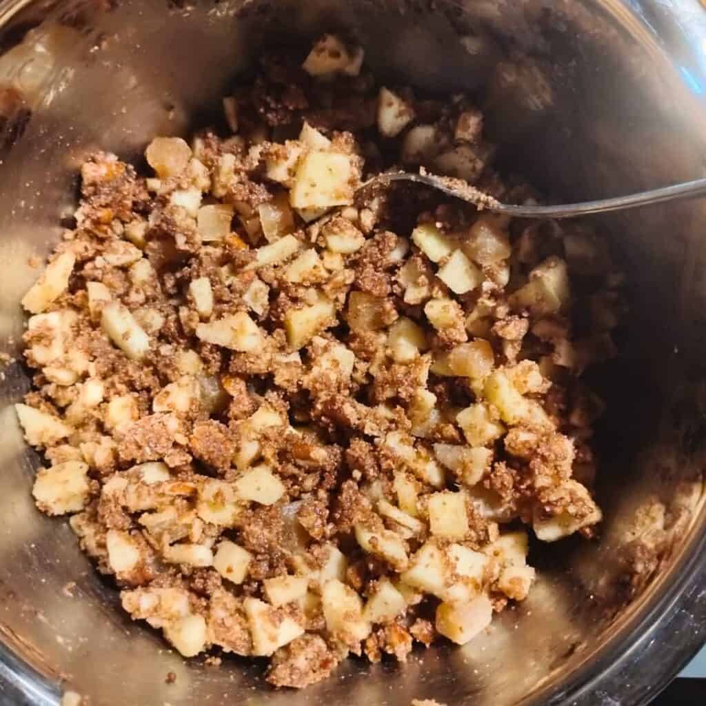 a mix of ingredients in a bowl for the apple ginger and pecan streusel topping. 