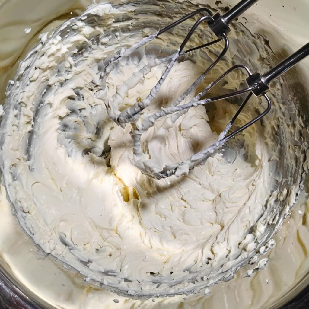 creamy cheese and cream batter with beater bars showing. 