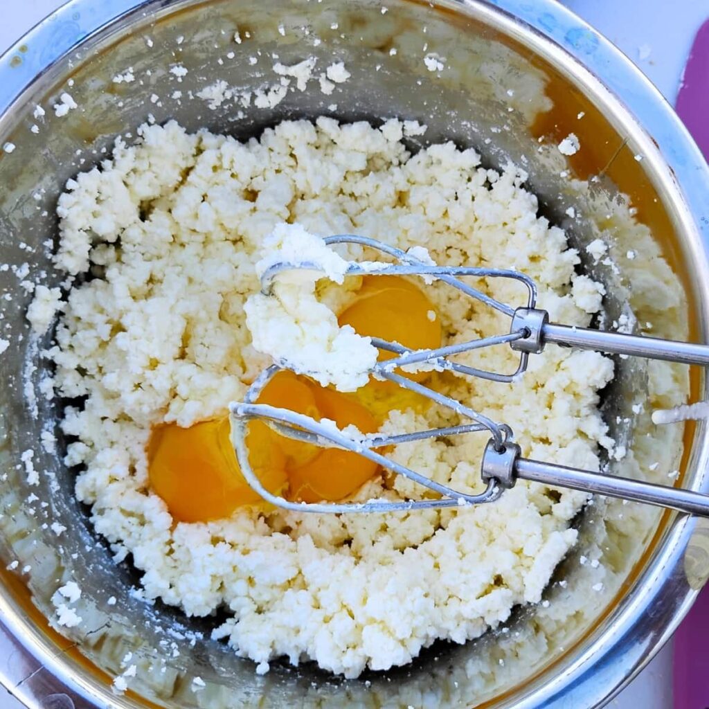 eggs were added to a bowl with creamy cheese batter. 