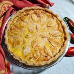 photo shows a whole baked jalapeno pie in a baking dish decorated wtih some fall leaves made of dough.