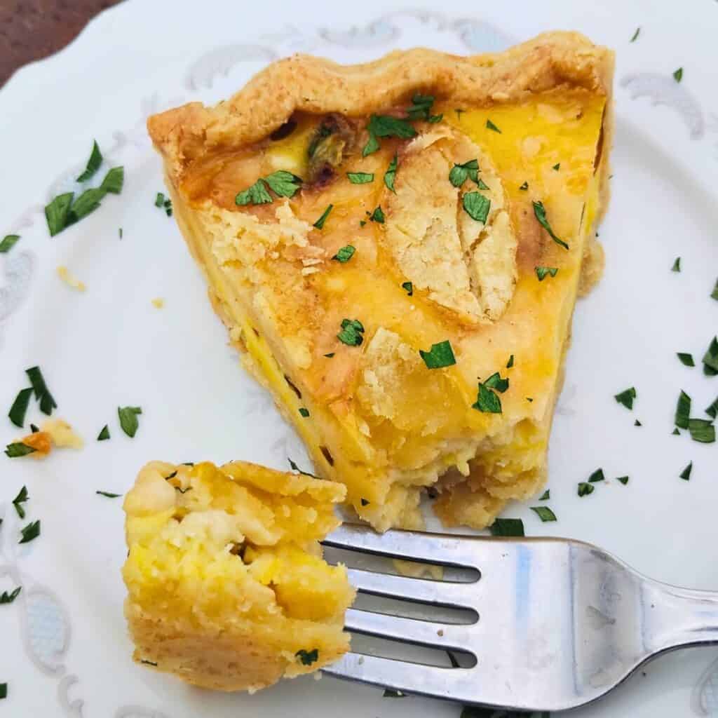 Photo of a slice of finished jalapeno pie and a piece of the pie on a fork, showing off the textures. 