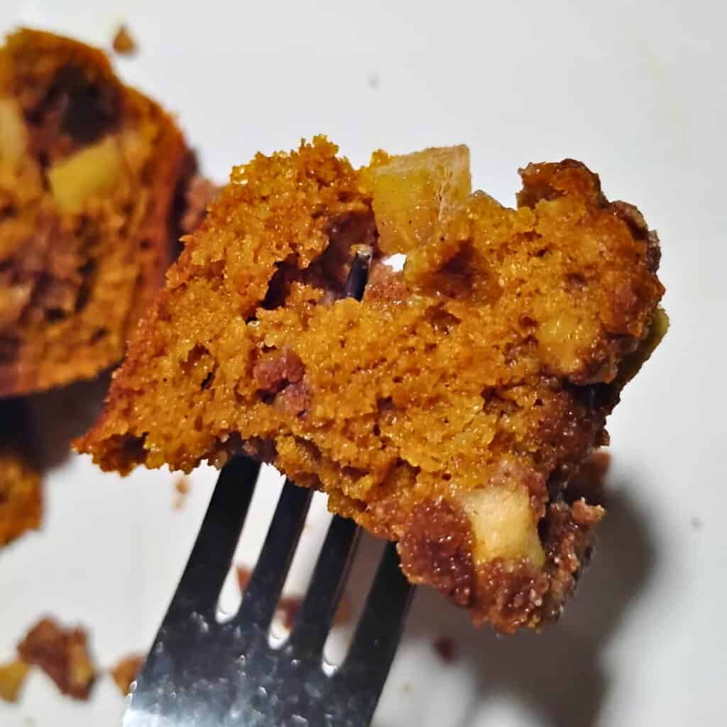 A piece of sourdough pumpkin cake with ginger, pecan & apple streusel on a fork 