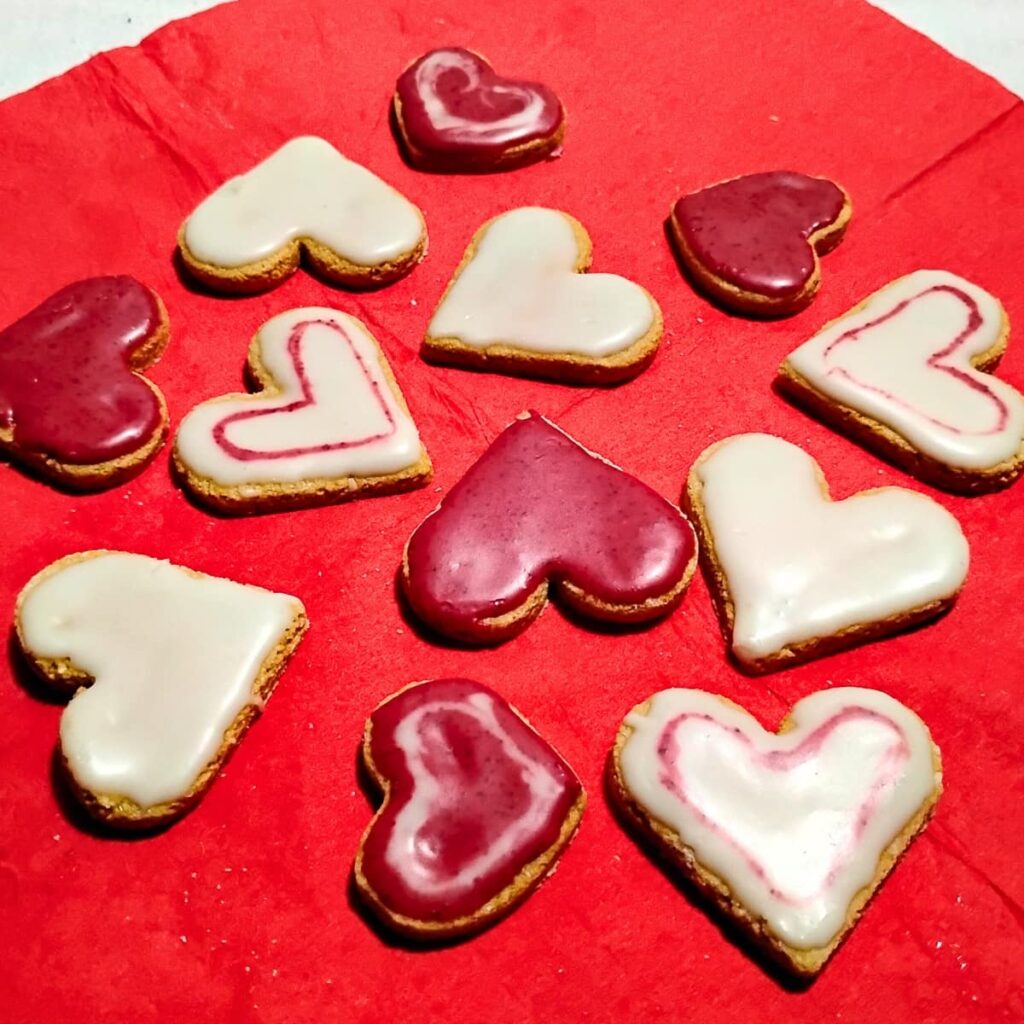 scattered lemon heart cookies on a red napkin.