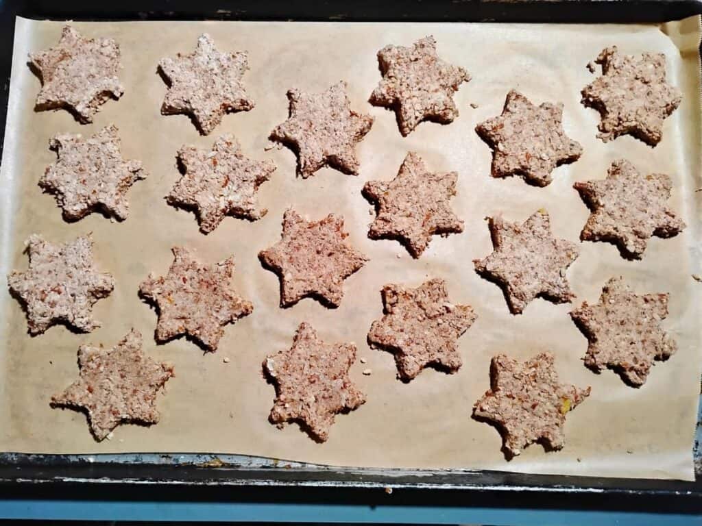 parchment lined baking sheet with cinnamon star cutouts
