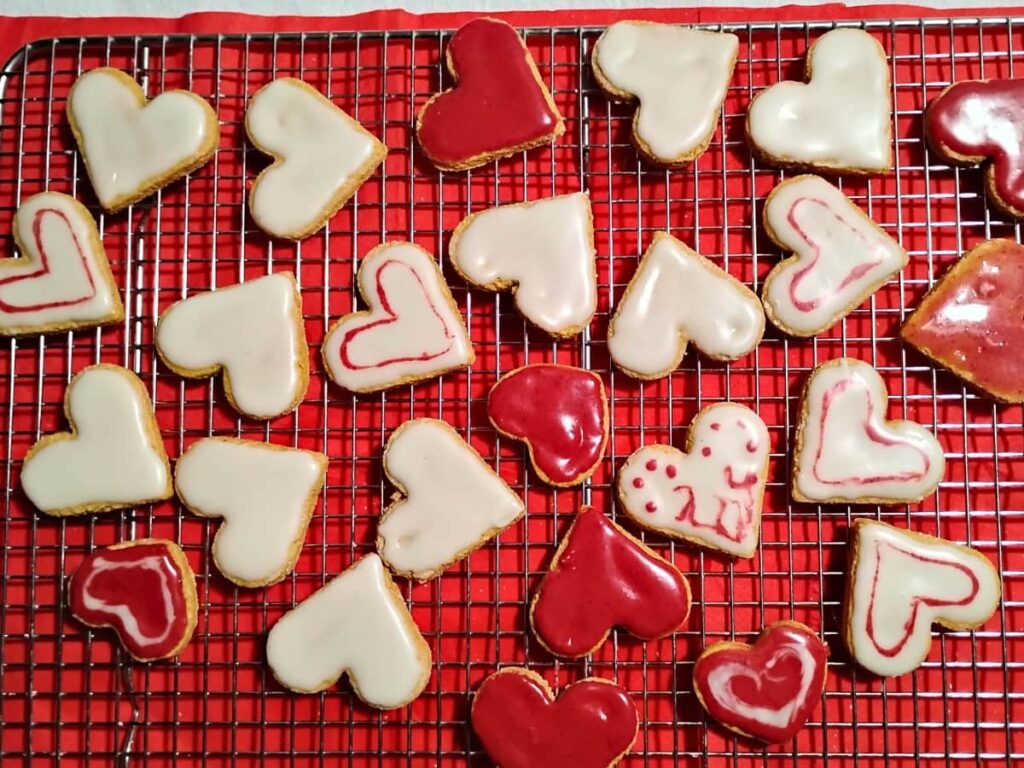 freshly iced lemon hearts drying on a cooling rack 