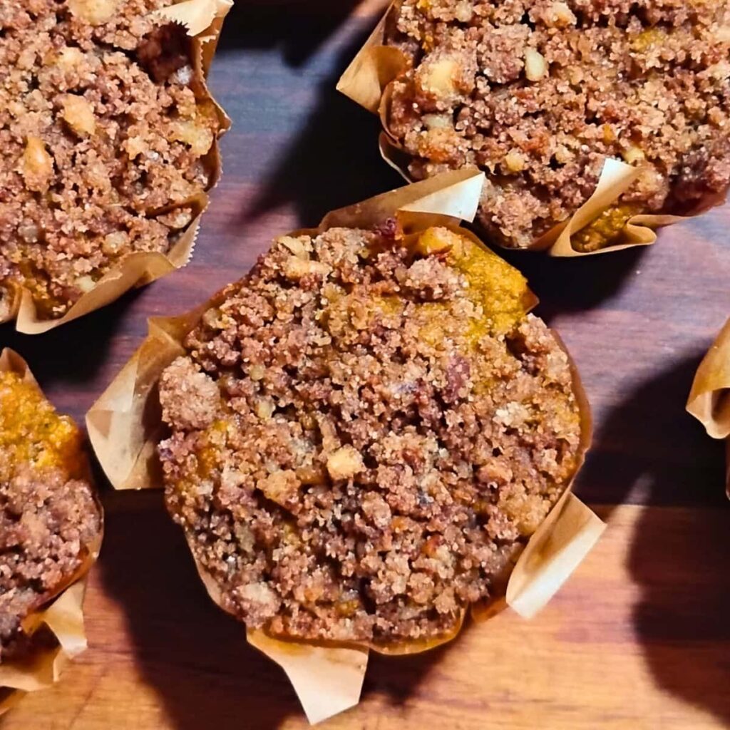 finished muffins in liners on a cutting board.
